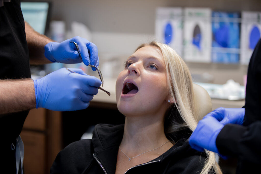 girl in chair about to get tooth extracted