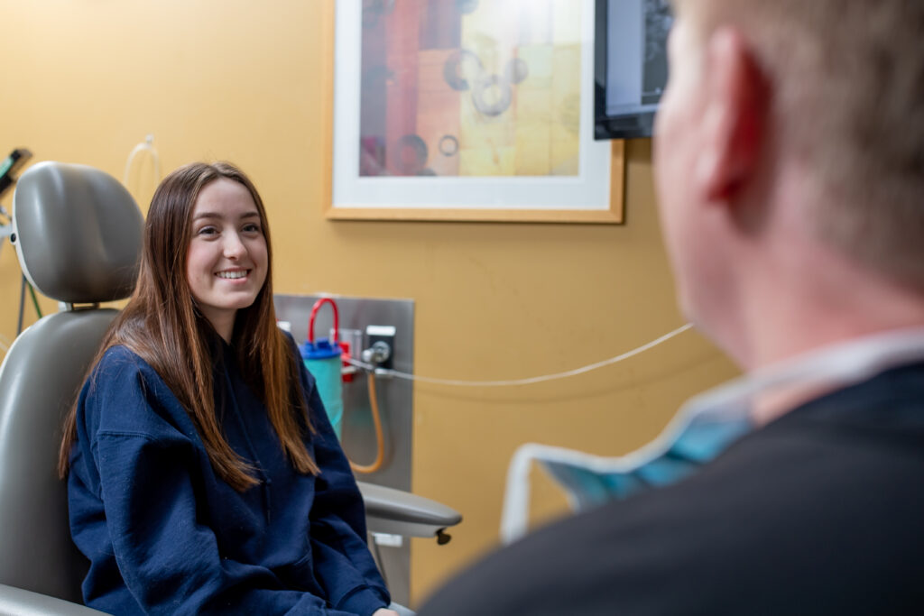 girl talking with oral surgeon